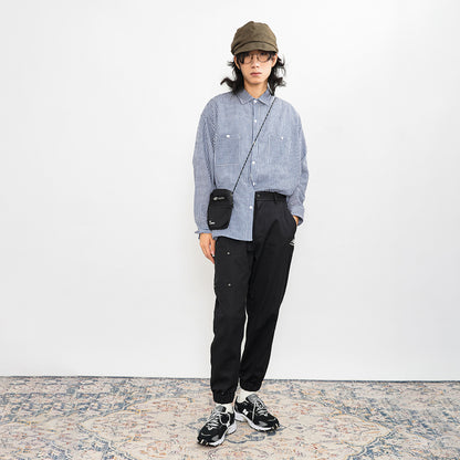 Katta oʻlchamli choʻntaklari boʻlgan New Balance erkaklar qora qishki kundalik shimlari